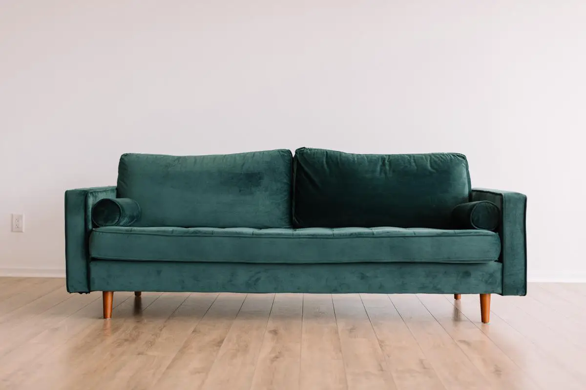 Comparison between a leather and fabric sofa, showcasing the different aesthetics and comfort levels they offer